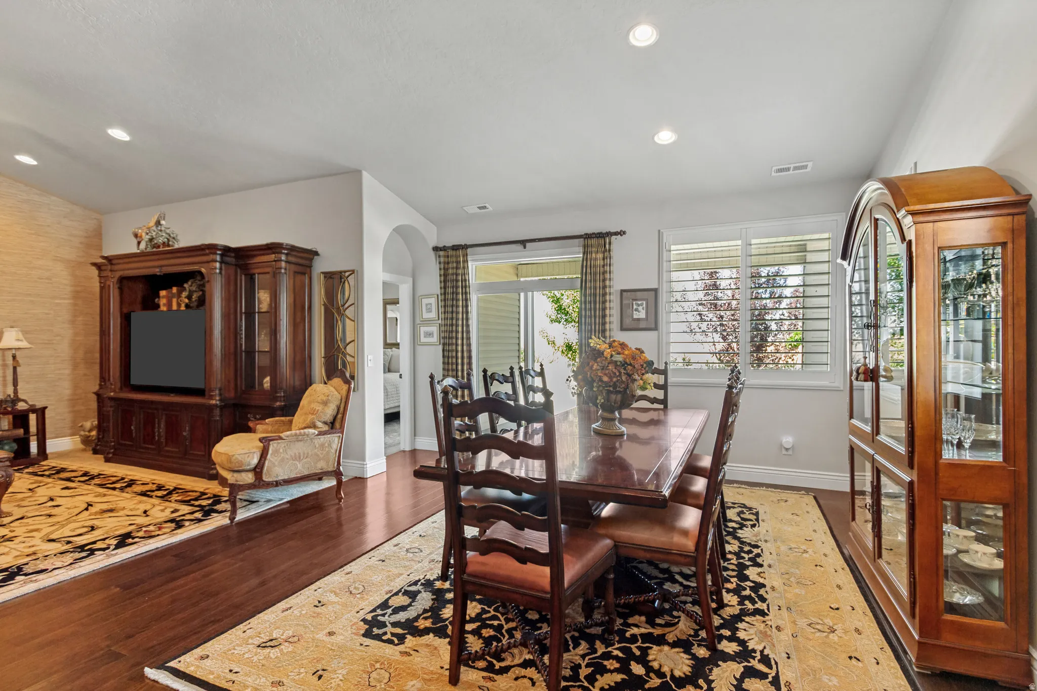 Bright interior space featuring wood-finish flooring, recessed lighting, white baseboards, and a glass-paneled patio door