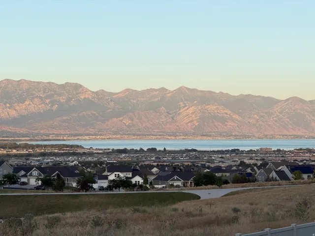 Expansive mountain range backdrop with a large body of water