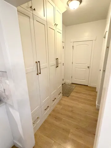 Custom built-in white cabinetry with gold-toned hardware