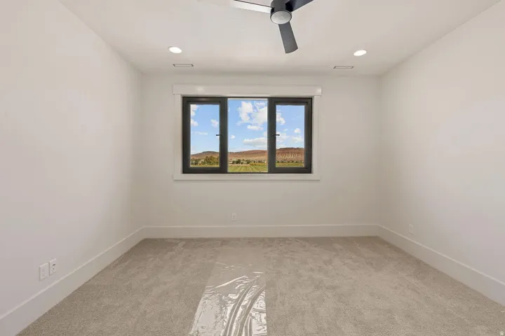 Room with light-colored carpeting and white walls