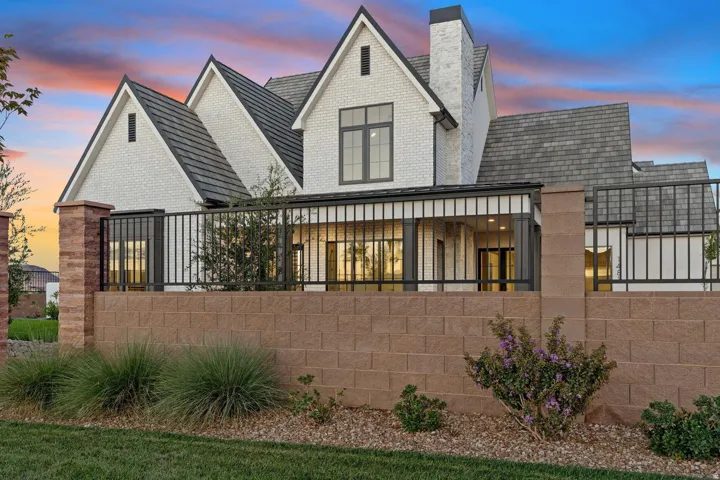 White brick exterior with prominent gables and dark gray roofing