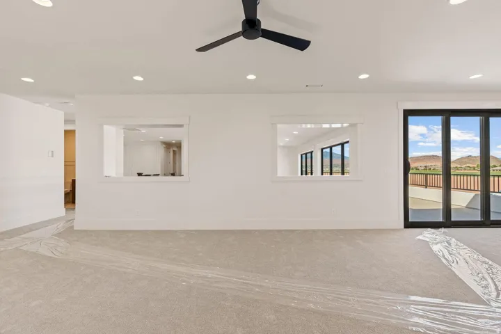 Spacious interior featuring neutral carpeting and recessed lighting