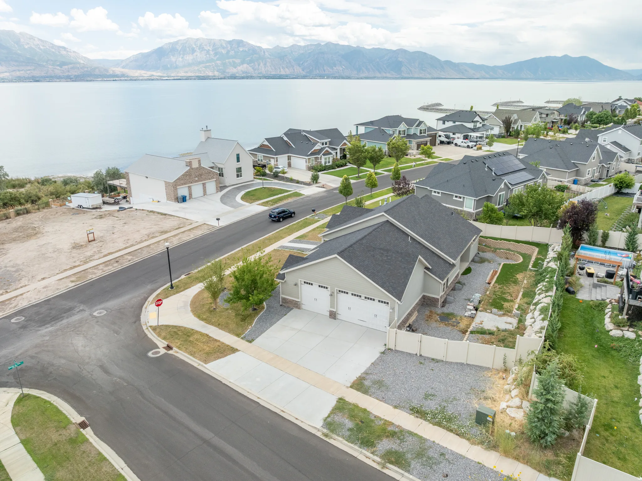 Aerial view of the property, street & lake