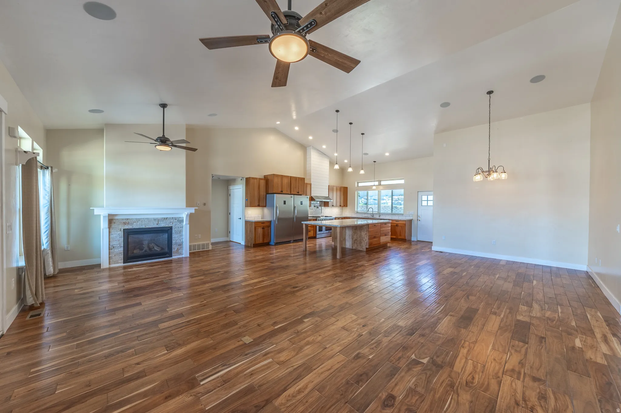 Great room is ideal for gatherings. Hard wood floors, vaulted ceilings, lots of natural light.