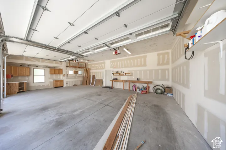 Garage is extra wide. 3rd car garage has cabinetry & 220 power - ideal for a workshop. Garage doors are 10' high, providing clearance for large trucks.