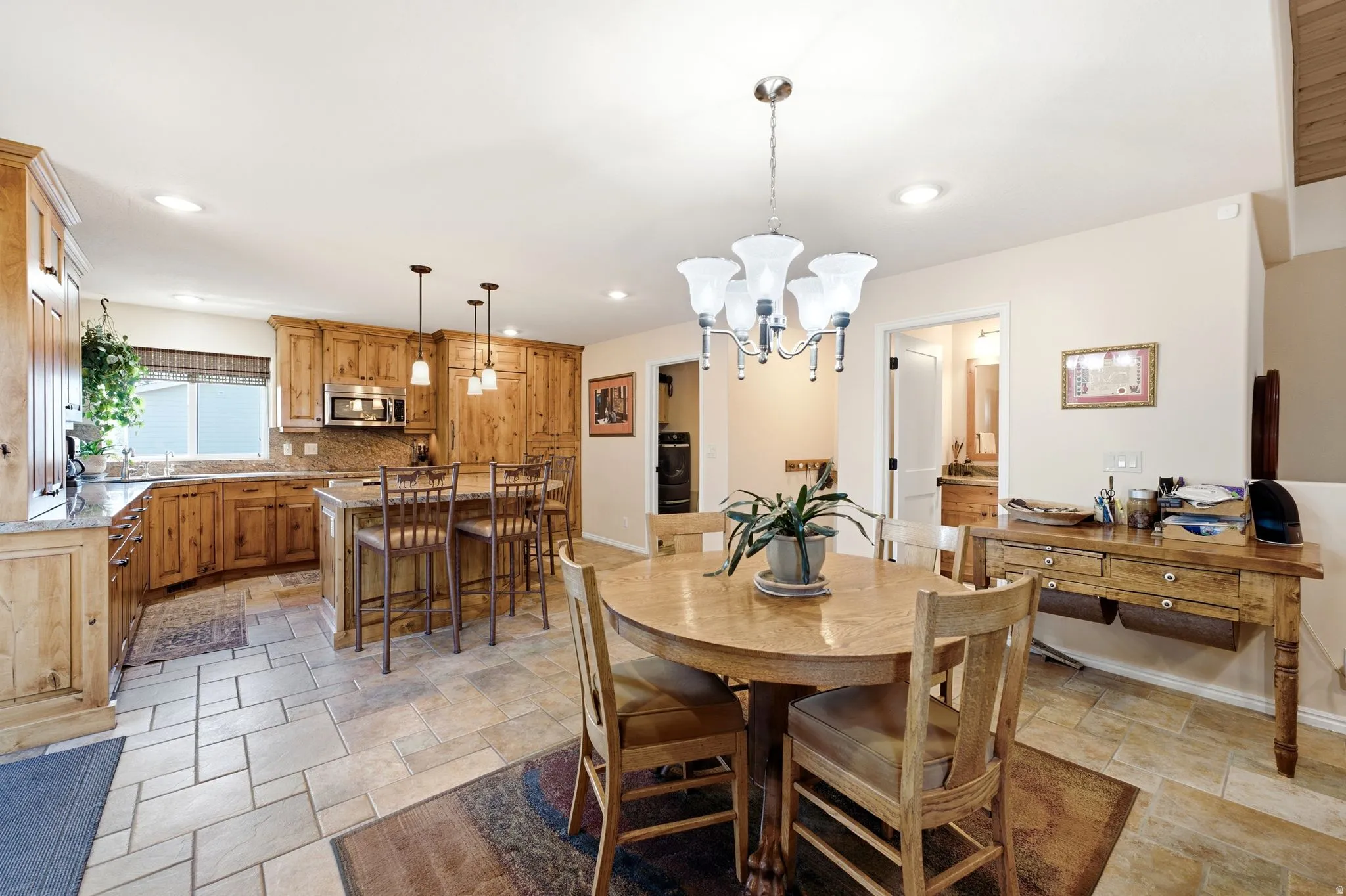 Kitchen featuring wood cabinetry, stone countertops, and a tiled backsplash