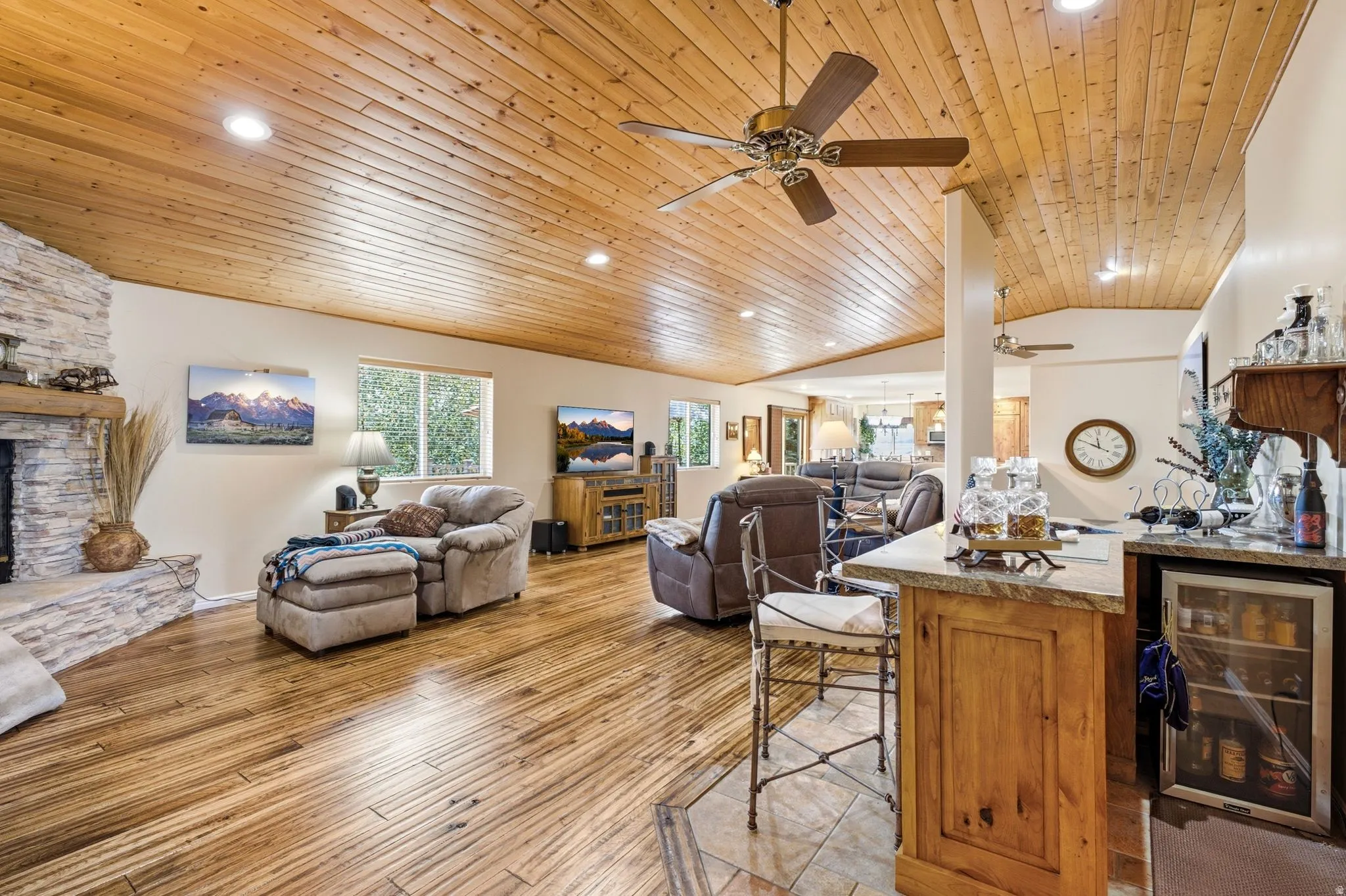 Vaulted wood-paneled ceiling with recessed lighting and ceiling fans