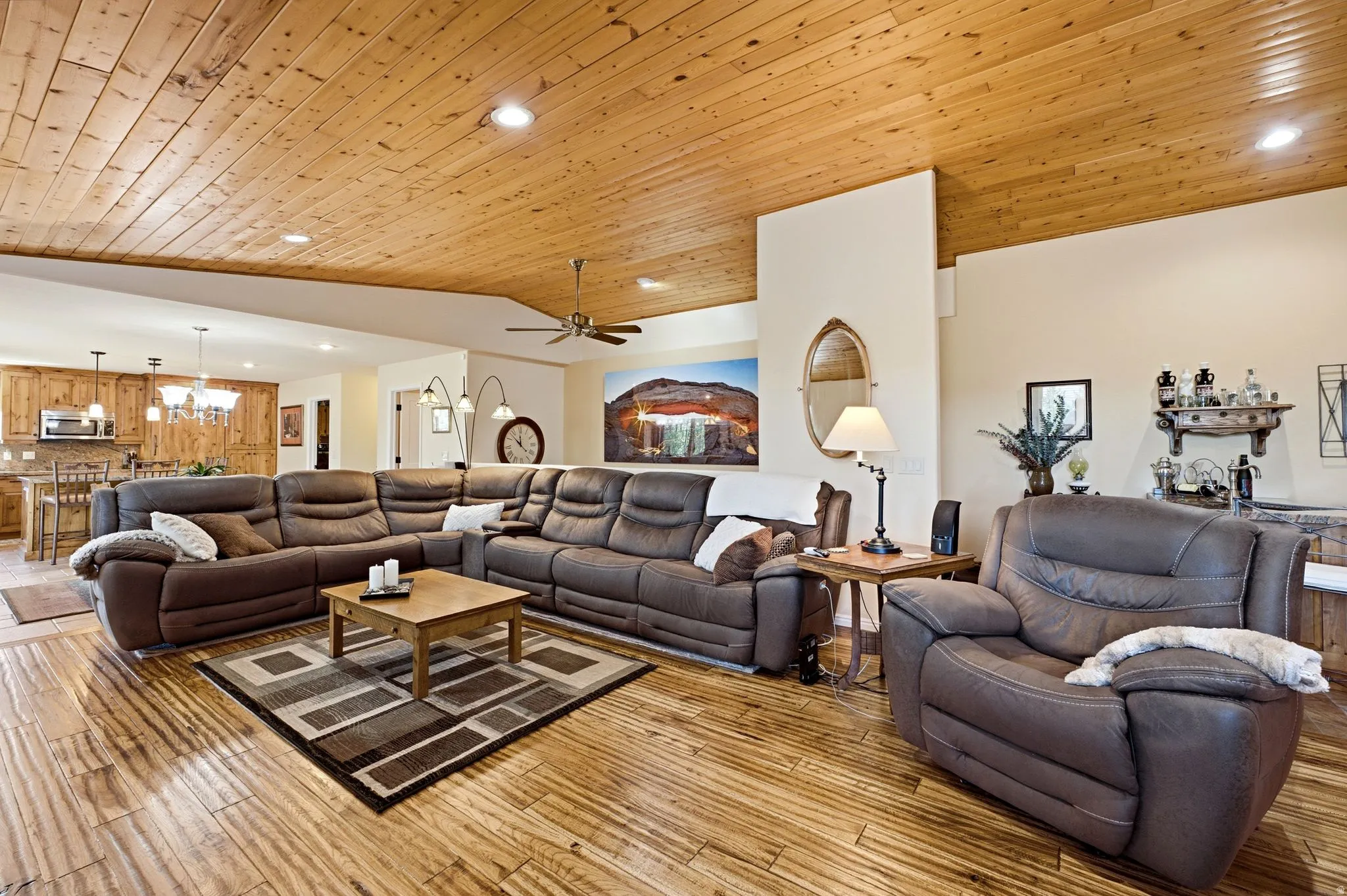 Expansive living area featuring a plank wood ceiling with recessed lighting and a ceiling fan