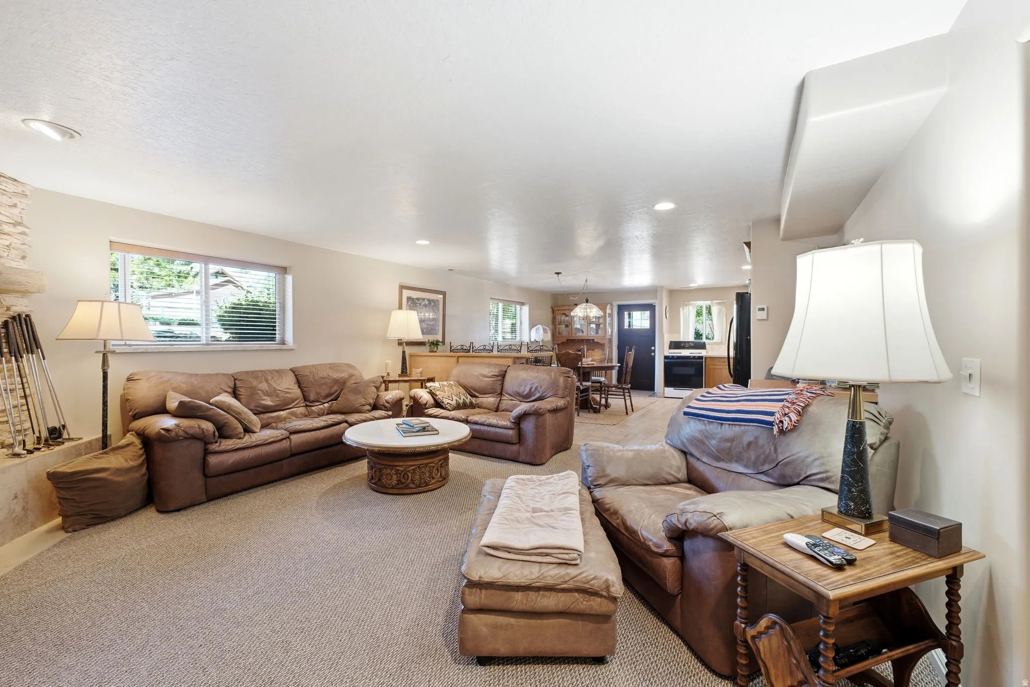 Spacious lower living area featuring neutral carpet flooring and recessed lighting