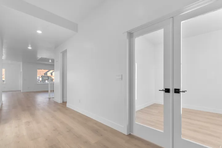 Entryway featuring light wood-finish flooring, recessed lighting, and a neutral color palette