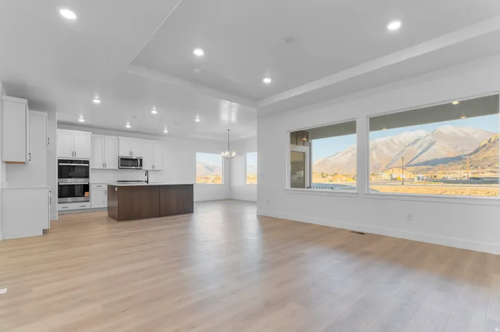Open-concept living area with light wood-finish flooring