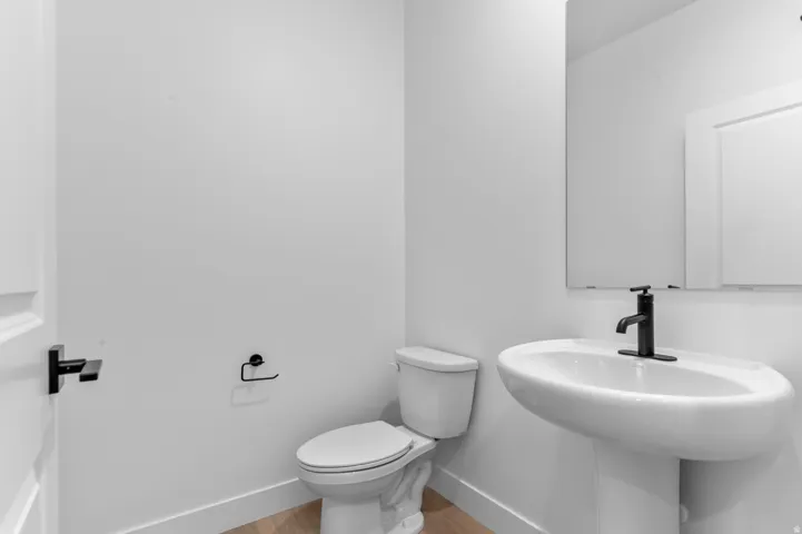 Modern pedestal sink with a matte black faucet