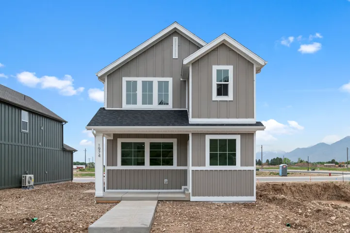 Contemporary two-story home featuring board and batten siding with white trim
