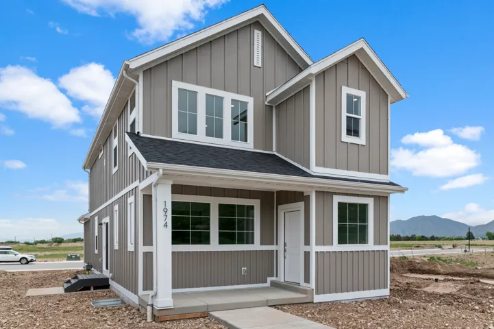 Contemporary two-story residence featuring board and batten siding in a neutral tone with white trim