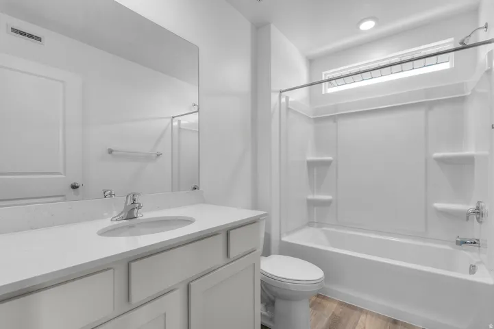 Bathroom featuring a vanity with an integrated sink, polished chrome faucet, and white countertop