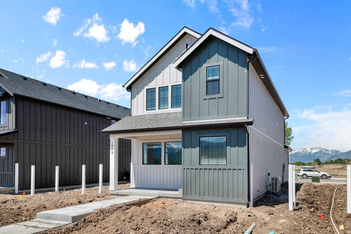 Modern two-story home featuring a combination of light and dark vertical siding