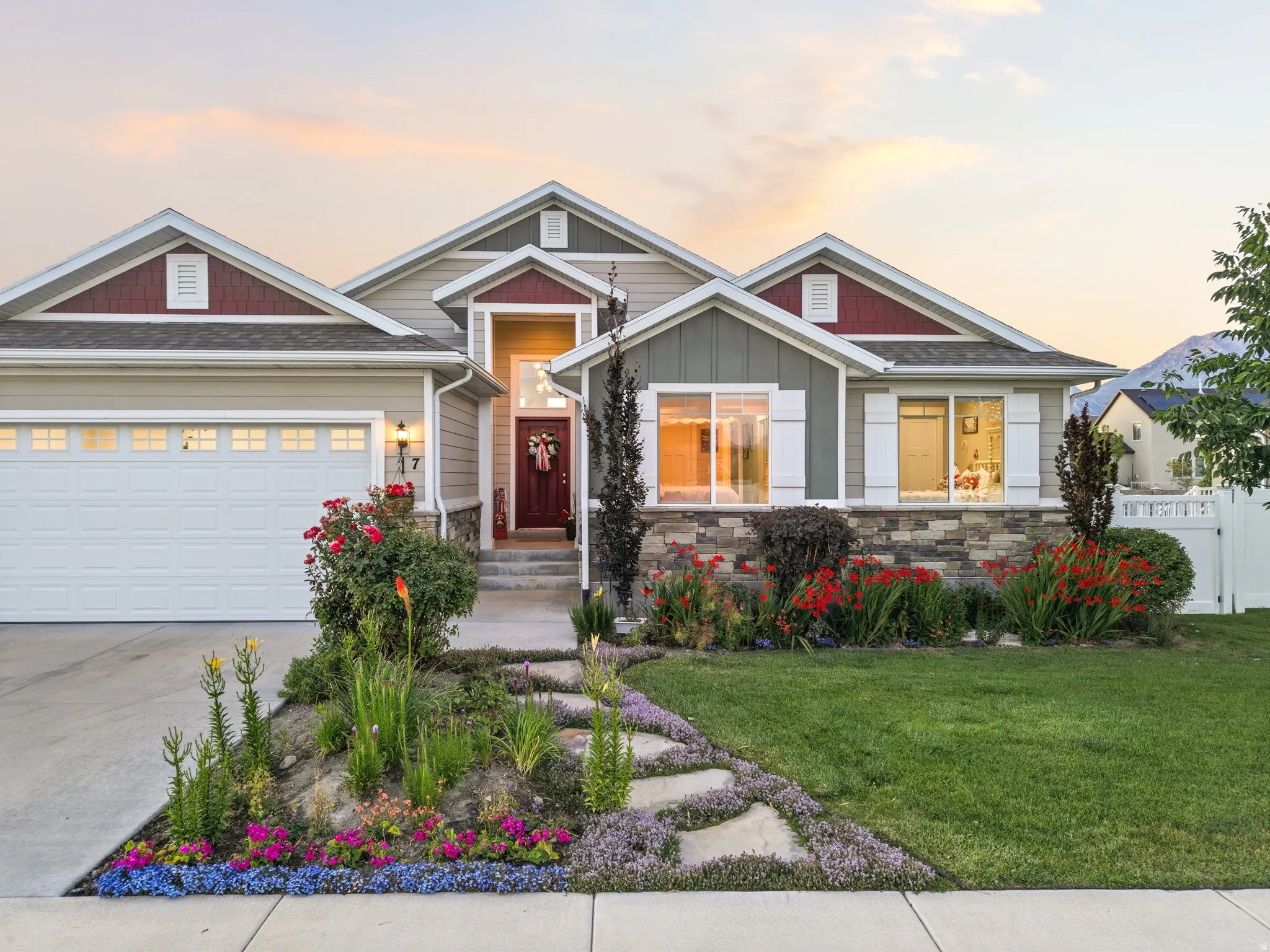 Craftsman-style home featuring a stone facade and variegated siding