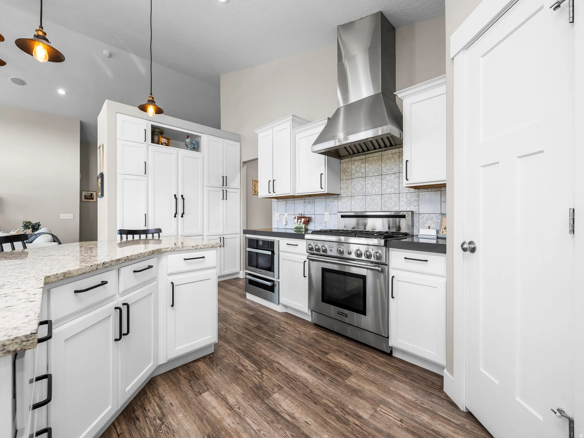 Kitchen featuring a stainless steel professional-grade range, coordinating range hood, and integrated microwave