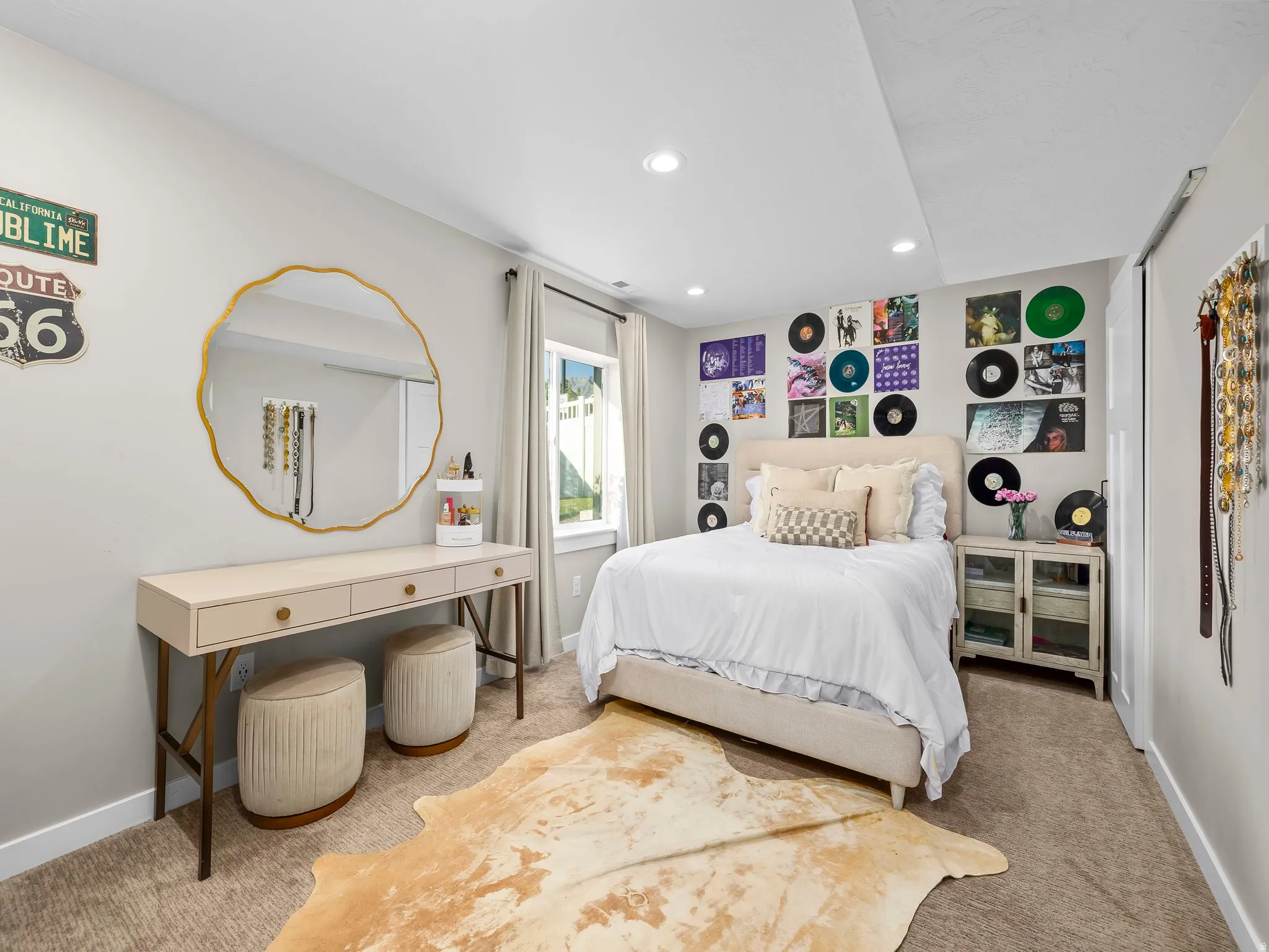 Carpeted room featuring a window with natural light, recessed lighting, and a built-in closet with a sliding door