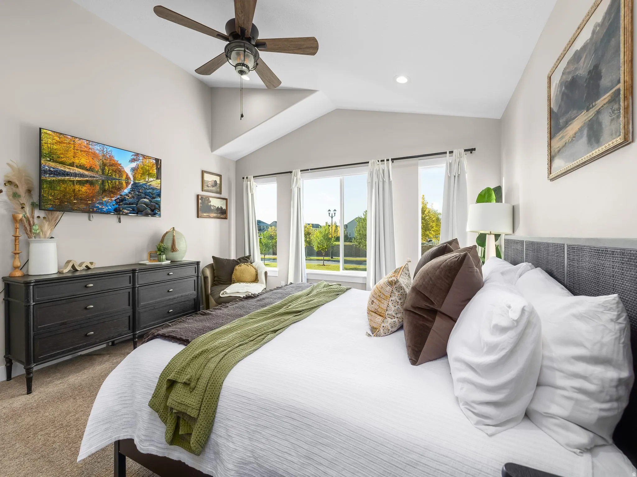 Vaulted ceiling with a ceiling fan and recessed lighting