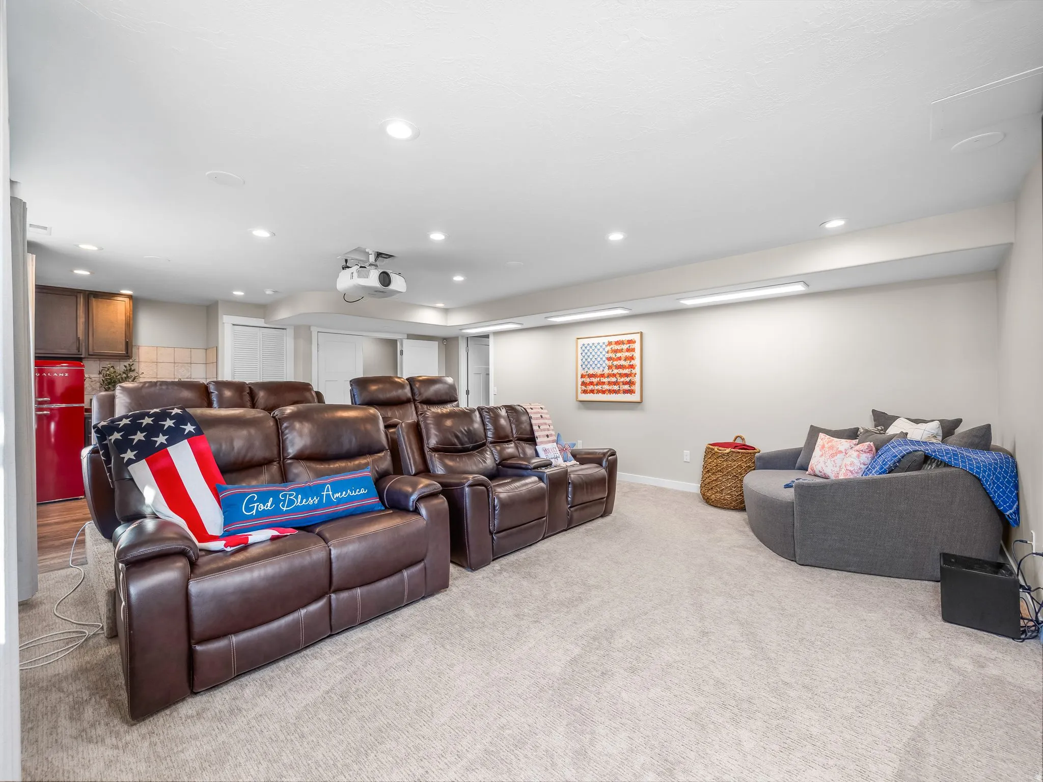Entertainment space featuring recessed lighting, a ceiling-mounted projector, and carpet flooring
