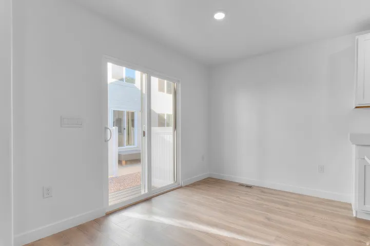 Bright interior space featuring wood-finish flooring and a sliding glass door