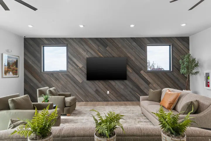 Accent wall featuring diagonal wood-finish paneling with two rectangular windows