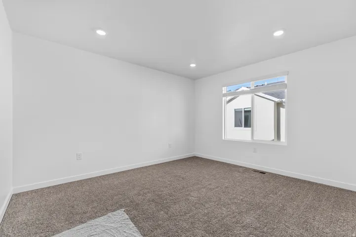 Room featuring soft brown carpeting and white painted walls