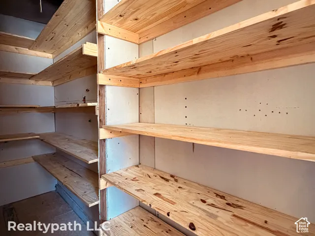 Extensive pantry with multiple tiers of wood shelving