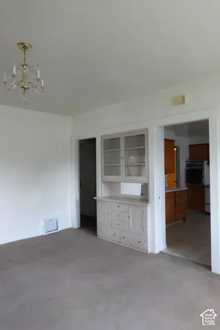 Spacious room featuring a vintage built-in hutch with glass-front cabinets and lower drawers