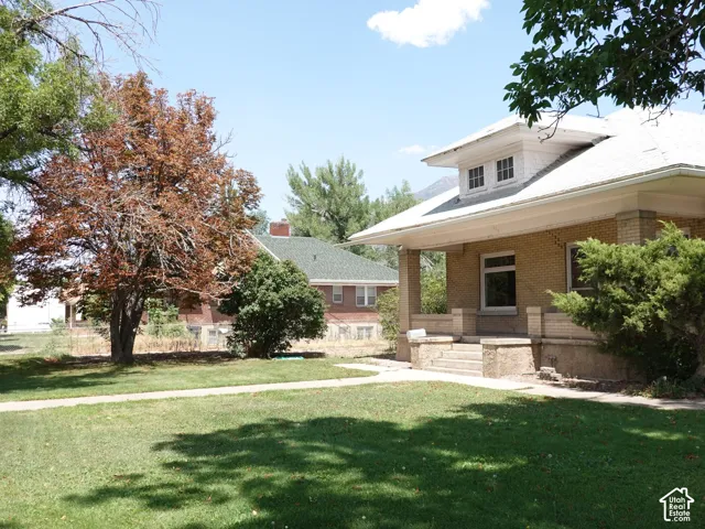 Craftsman-style home featuring a brick exterior and a dormer window