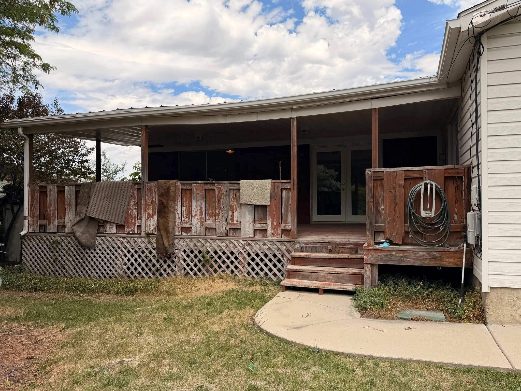 Covered deck with a metal roof and painted wood flooring