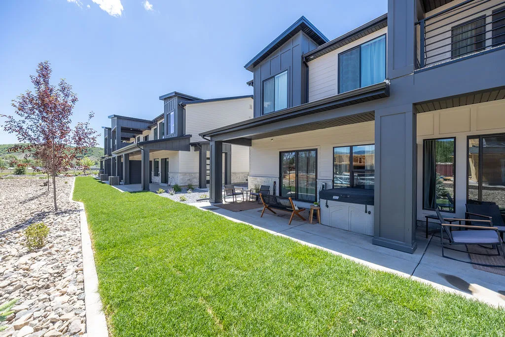 Landscaped common area with private hot tub & patio- furnishings included.