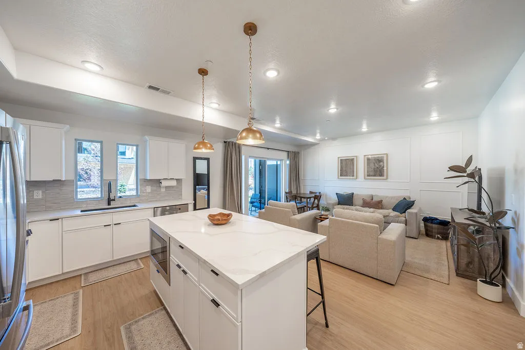 Spacious main level with plenty of seating and added decorative moulding .