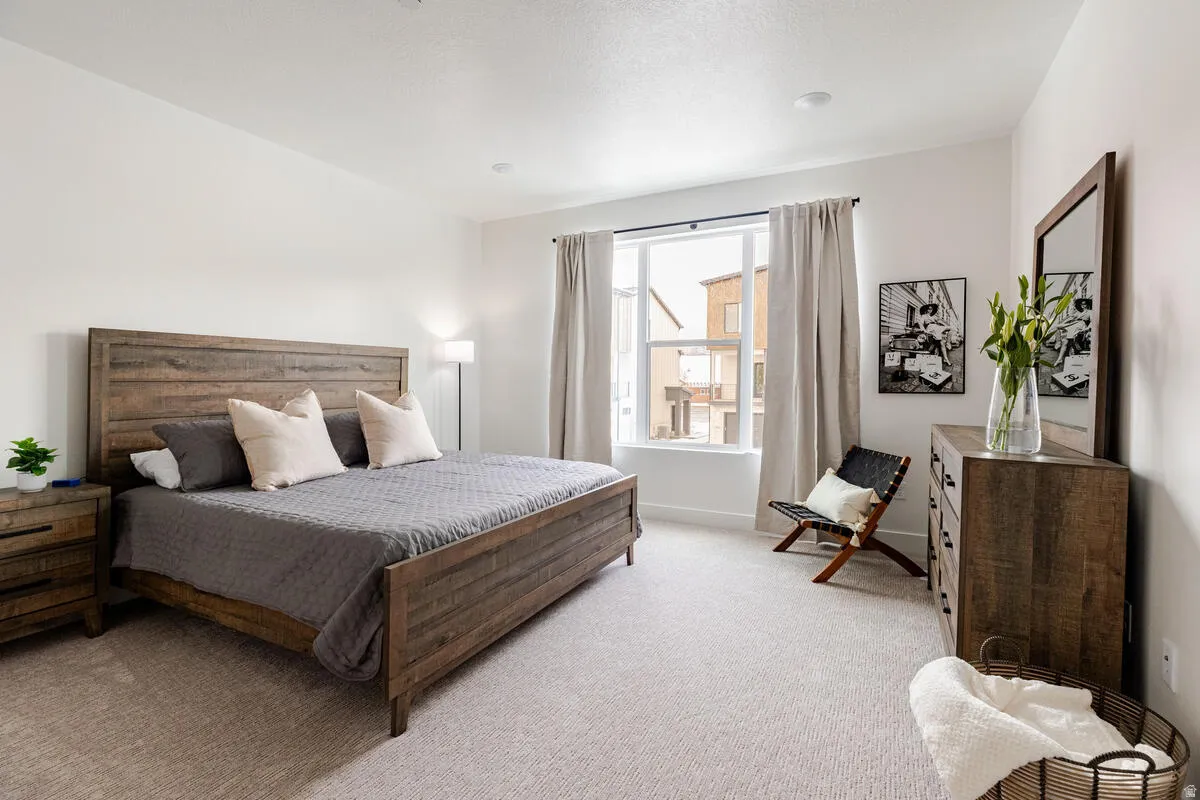 Primary bedroom with large walk in closet, large windows and full ensuite bathroom.