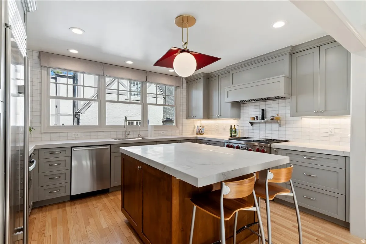Kitchen with a central island featuring a light-toned countertop