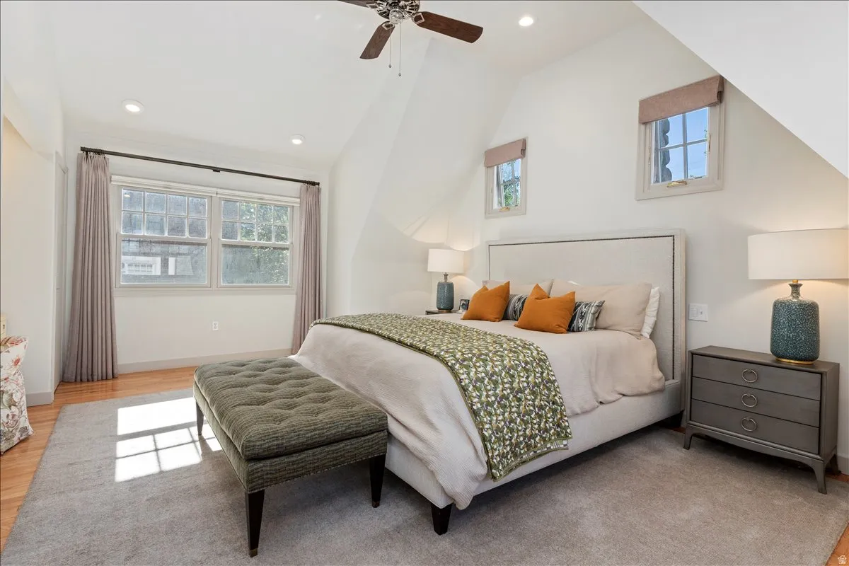Room featuring recessed lighting, a ceiling fan, light wood-finish flooring, and a large window with additional smaller windows