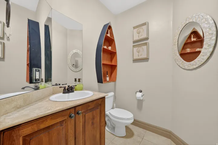 Bathroom featuring a wood vanity with a light-colored countertop and an undermount sink