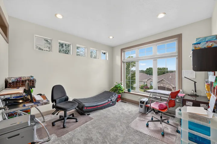 Room featuring extensive natural light from a large picture window and high transom windows