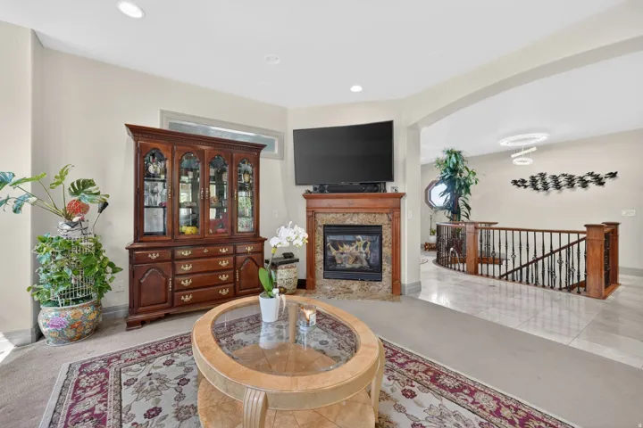 Living area featuring a fireplace with a stone surround and wood mantel