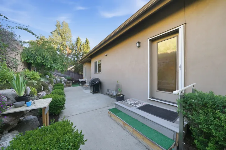 Stucco exterior with a rear door featuring a glass panel