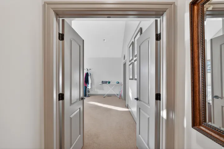 Interior doorway with paneled doors and dark hardware