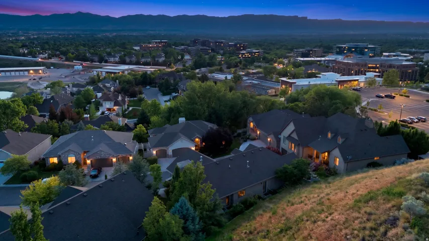 Aerial perspective of a residential neighborhood with distant mountain ranges