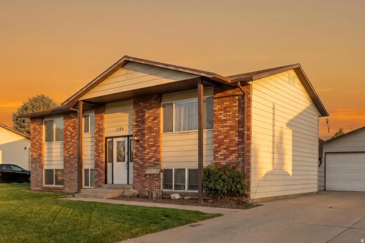 Split-level residence featuring a brick and siding exterior (Digitally enhanced to show lawn potential)