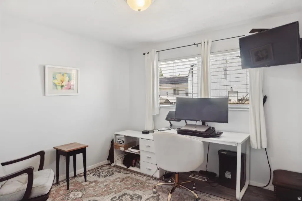 White walls, dual windows with blinds, and recessed lighting highlight this room
