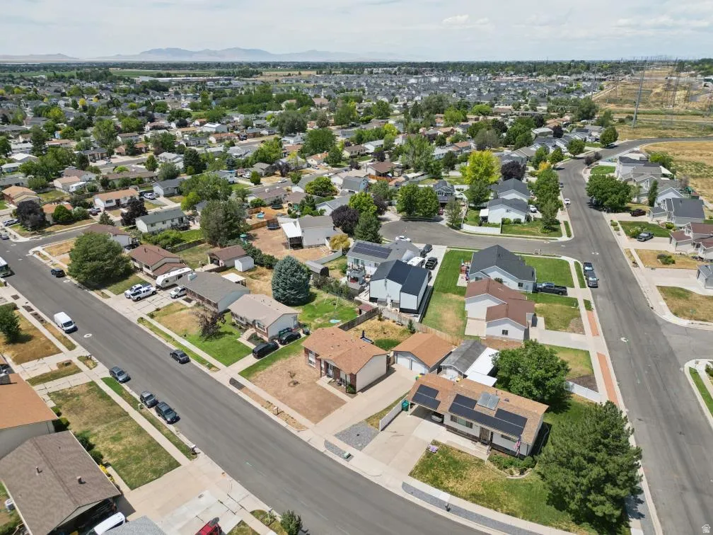 Residential streetscape featuring single-story and two-story homes with varied rooflines