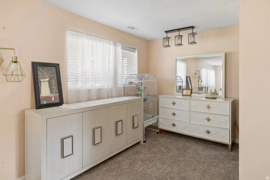 Room featuring neutral wall tones and textured carpeting
