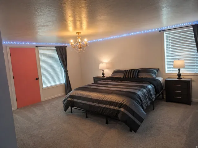 Plush gray carpet flooring complemented by a coral-colored interior door
