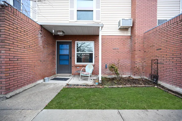 Brick-clad facade with contrasting light-colored siding