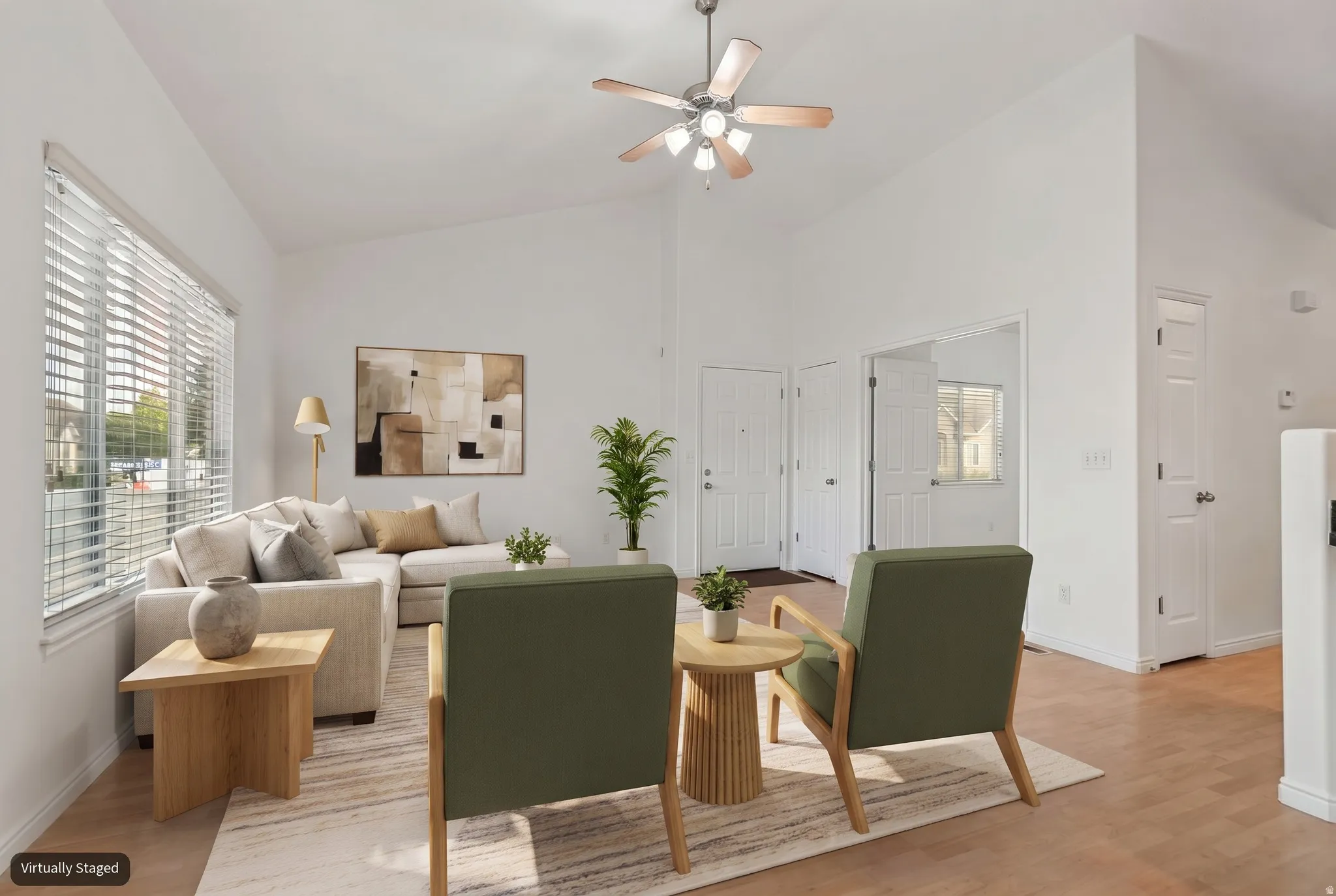 Spacious interior featuring vaulted ceilings and wood-finish flooring (virtually staged)